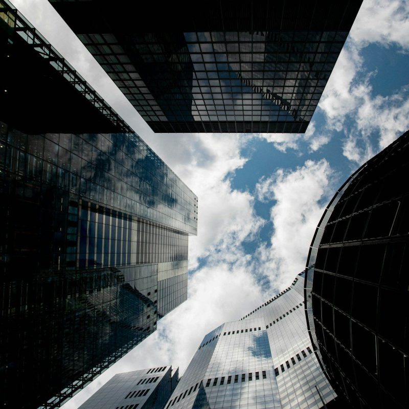 Modern skyscrapers reaching towards a cloudy sky