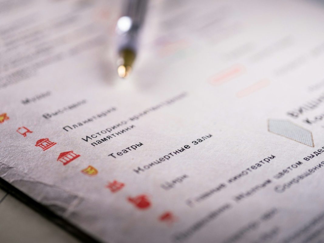 Pen rests on a list of places, with icons.