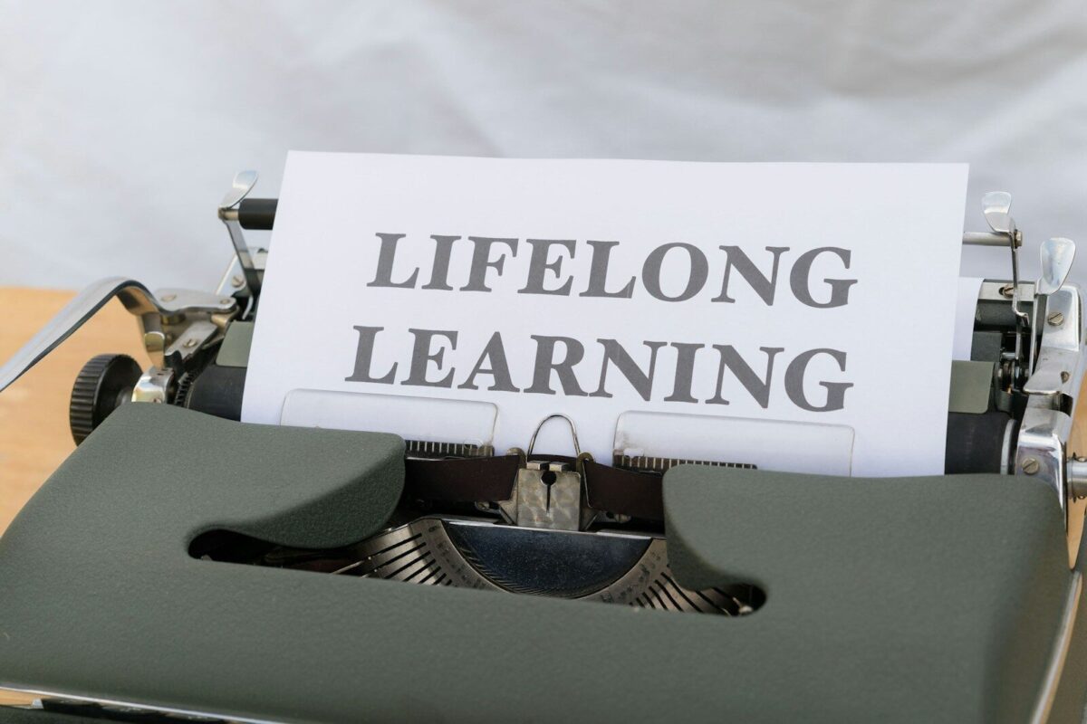 a close up of a typewriter with a sign on it