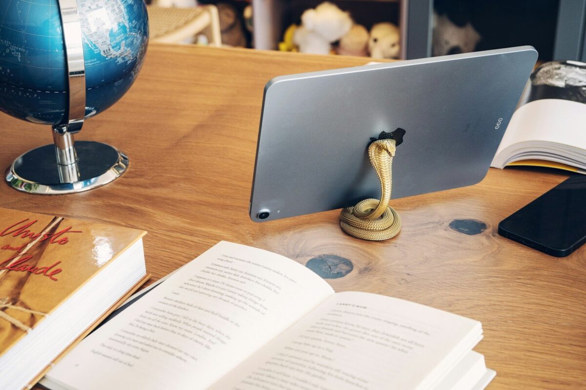 a laptop computer sitting on top of a wooden desk